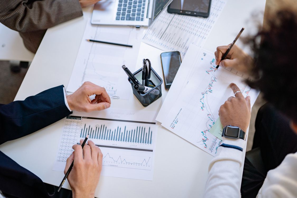 Business team analyzing financial charts and data